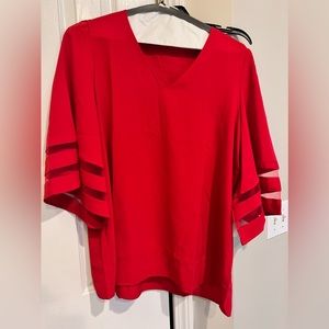 Cute red blouse.  Dress it up or down.